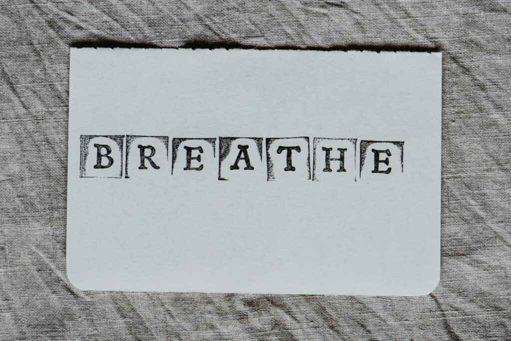 pexels photo 6475297 6475297 Minimalist typography with the word 'breathe' on textured fabric background, promoting mindfulness.